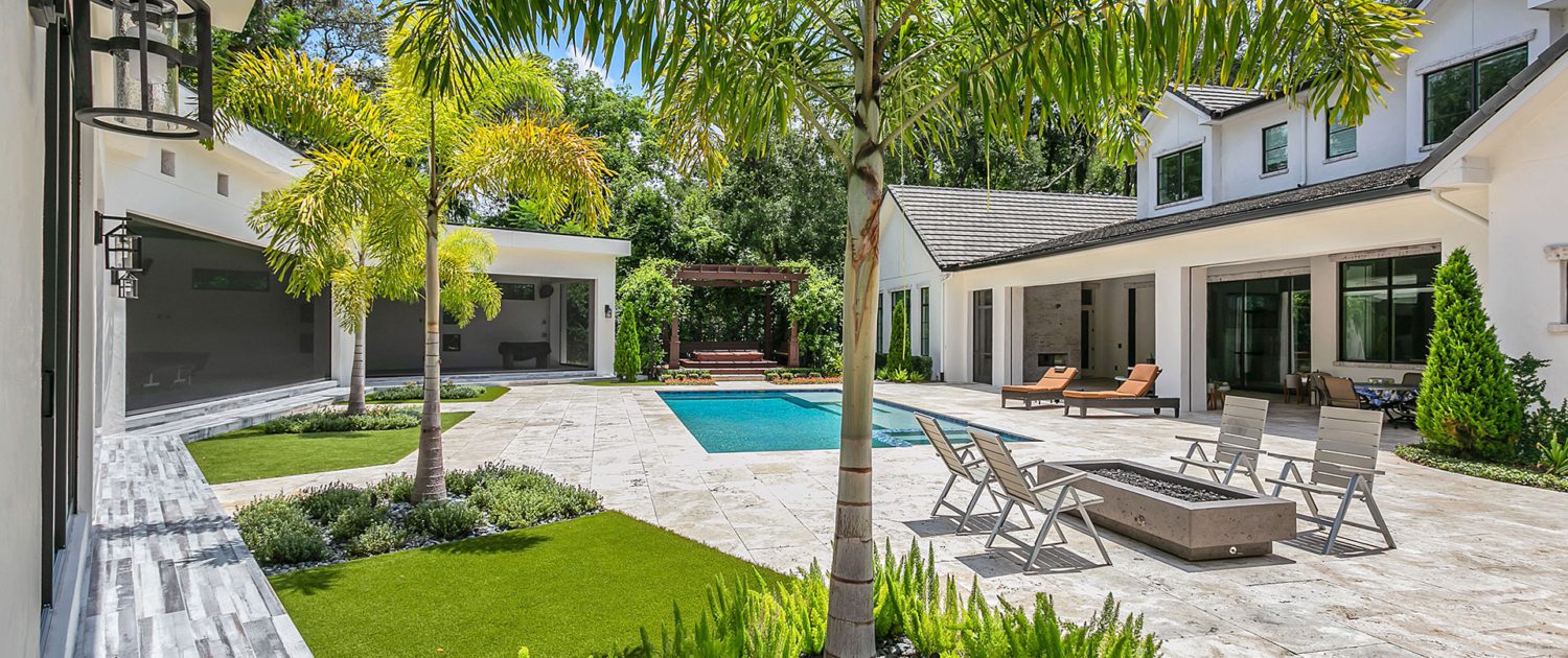 Backyard design for an Orlando estate home featuring integrated outdoor living spaces, layered landscape planning, and cohesive residential outdoor composition by BLG Environmental Services