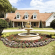 Estate home with landscaped front yard, circular driveway, and decorative fountain in Orlando, Florida