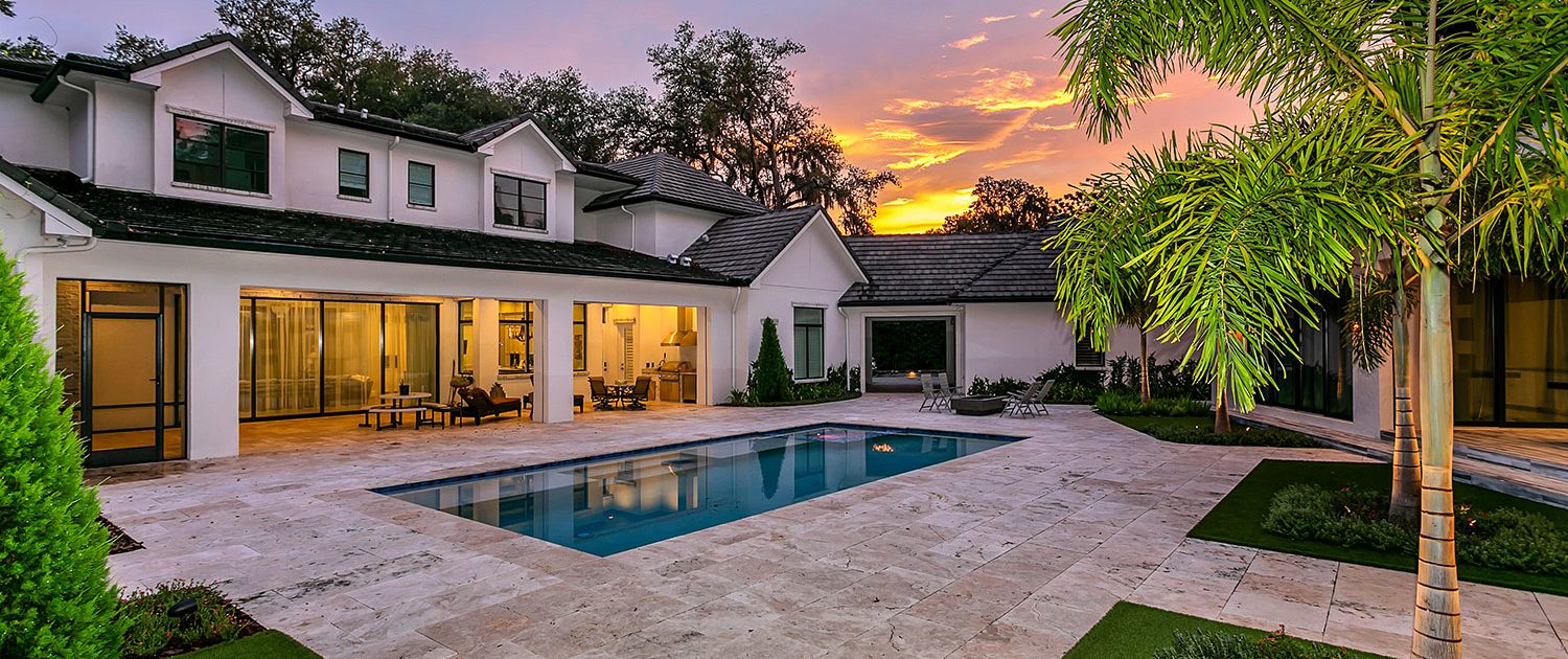 Luxury outdoor living design in Orlando, Florida featuring custom pool, patio hardscapes, and integrated landscape architecture