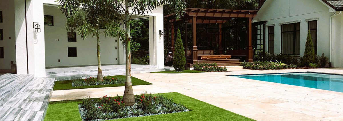 Luxury outdoor living design on an Orlando estate featuring integrated pool, pergola, modern patio, and structured landscape layout