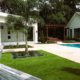 Luxury outdoor living design on an Orlando estate featuring integrated pool, pergola, modern patio, and structured landscape layout