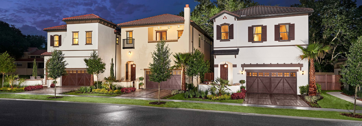File Name:\ `orlando-residential-landscape-design-evening-lighting.jpg` Alt Tag:\ `Orlando residential landscape design featuring three Mediterranean-style homes with manicured lawns, palm trees, ornamental plantings, and landscape lighting at dusk.`